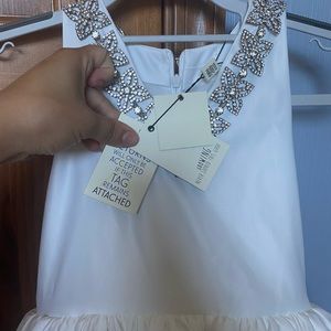 Brand new never worn pageant flower girl dress. Size 8 years in bridal white